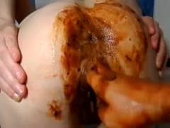 Big ass chick shits while getting fisted
